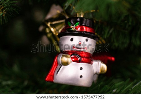 white snowman in red scarf and black top hat