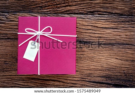 Gift box on wood table. Top view, copy space
