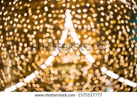 Adstract blurred yellow christmas light bokeh decorate in xmas festival.