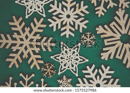 Rustic handmade snowflakes for Christmas flat lay background.Hand made wooden crafts for New Year home decoration.Eco friendly home decor made from natural wood material