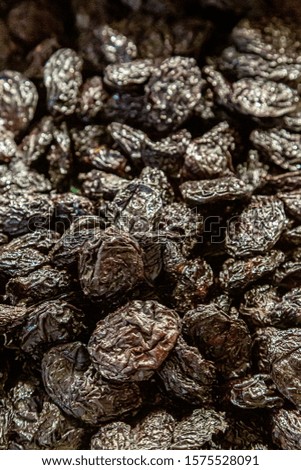 A full frame photograph of prunes for sale on a market stall