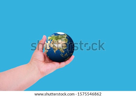 Planet earth in hand on a colored background with place for text. Earth day concept. Ecological problem