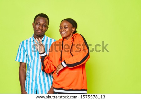 Man and woman of African appearance studio relationship luxury lifestyle Green background