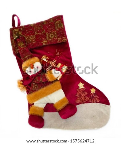 Red Christmas sock with decorations isolated on a white background. Santa's red stocking. Concept of Christmas or holiday.
