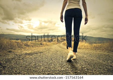 woman walking towards unknown places Royalty-Free Stock Photo #157563164