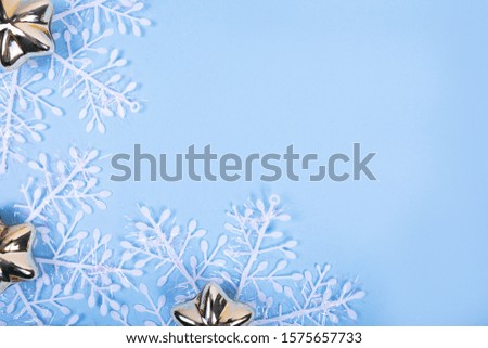 Solid blue background with white snowflakes and golden stars, space for text, chrsitmas greeting card template
