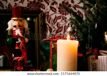Christmas decorations gifts with burning candle and tree and nutcracker very cozy and high quality picture photo