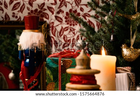 Christmas decorations gifts with burning candle and tree and nutcracker very cozy and high quality picture photo