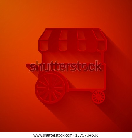 Paper cut Fast street food cart with awning icon isolated on red background. Urban kiosk. Paper art style. Vector Illustration