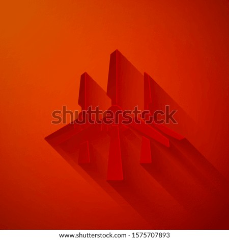 Paper cut Wind turbines icon isolated on red background. Wind generator sign. Windmill silhouette. Windmills for electric power production. Paper art style. Vector Illustration
