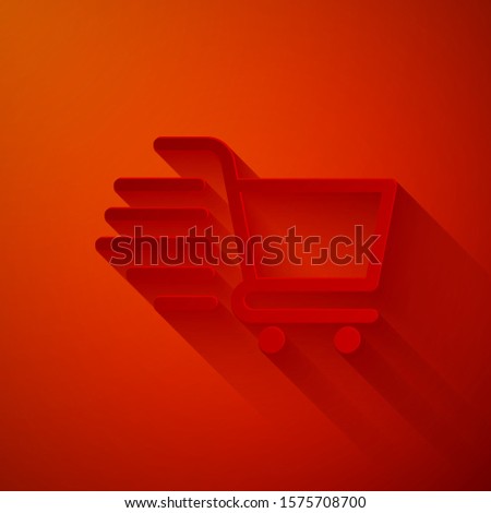 Paper cut Shopping cart icon isolated on red background. Online buying concept. Delivery service sign. Supermarket basket symbol. Paper art style. Vector Illustration