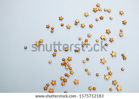 Wooden stars on a blue background as a concept of the starry sky