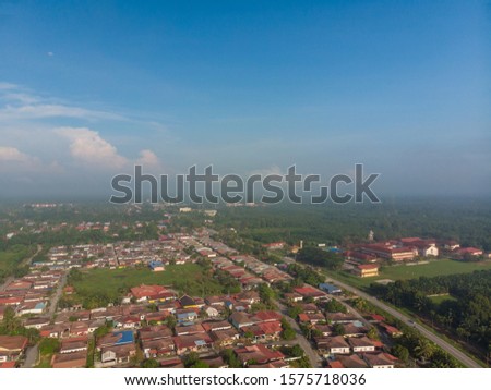 Aerial shot over the residences with blue sky background.