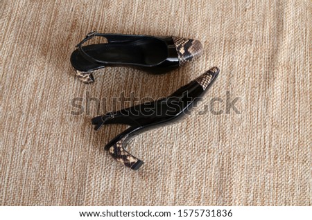 A pair of woman's shoes on a wooden floor.