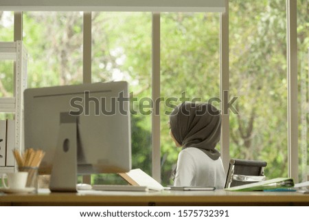 Muslim businesswoman wearing hijab Work in the office with pleasure in a natural office atmosphere.