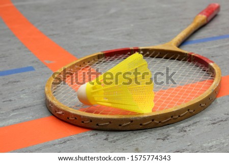 Badminton untensils on the floorof a gym.