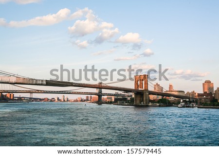 Sunset over New York City, filming on the south side of the Brooklyn Bridge, Brooklyn Bridge in the frame, water surface, embankment.Photos from my month tour of America