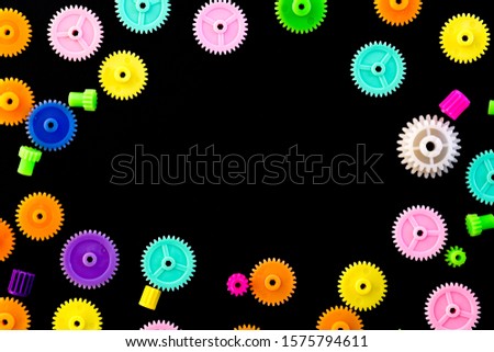 Colorful gears on a black background
,concept of work process movement gears