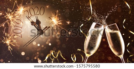 New Years Eve celebration background. Toast with fireworks and champagne at midnight