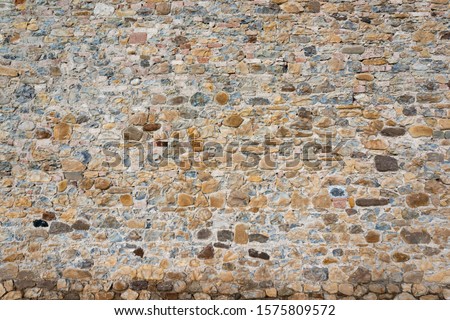 Stone wall background and ancient tuff, Tuscany in Italy
