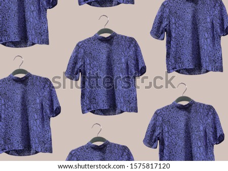 Elegant purple animal print chiffon woman blouses on hangers isolated on beige background. Minimal style. Composition of clothes. Fashion concept pattern. Flat lay. 90s fashion