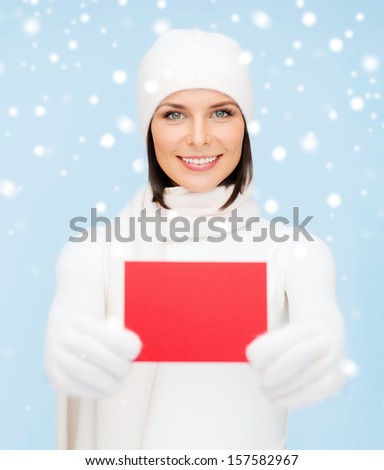 christmas, x-mas, people, advertisement, sale concept - happy woman in winter clothes with blank red card