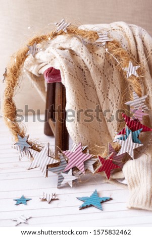 Star christmas wreath in soft colors over stool with a wool blanket.Warm Scene Christmas Decoration
