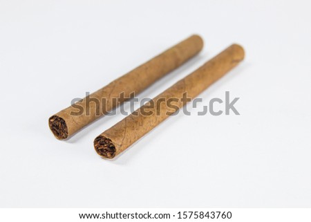 
two cigars on white background