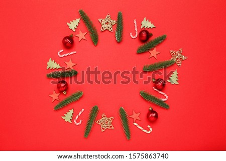 Flat lay christmas composition. Ornaments on red background