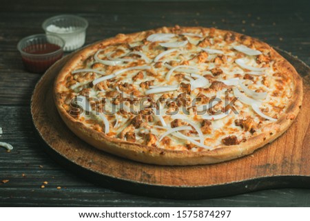 Stock image of Very cheesy pizza slice  placed on wooden table 