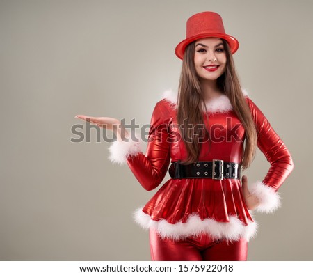 Closeup shot of a beautiful Santa helper girl in red costume