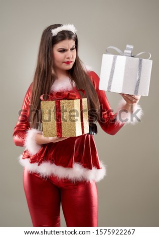 Santa girl undecided between presents