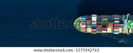 Aerial drone panoramic photo of industrial container tanker cruising in open ocean deep blue sea