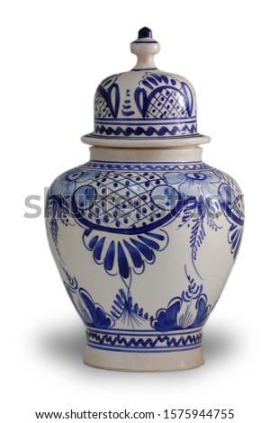 lidded vase decorated in blue isolated on white background Royalty-Free Stock Photo #1575944755