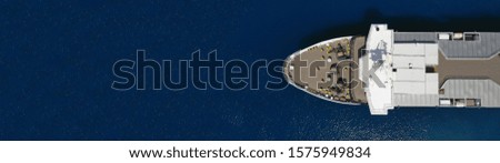 Aerial drone top view photo of large passenger ship docked in deep blue sea