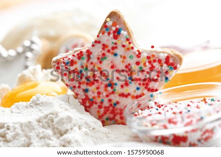 Still life, baking ingredients and Christmas cookies, colourful sugar pearls