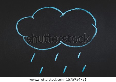 a cloud with rain drawn with a chalk on a blackboard
