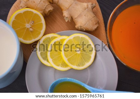 Jam with sea buckthorn juice with ginger and lemon on a wooden background. Conceptual autumn vitamin drink to enhance health and immunity.