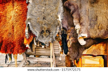 Fur hats on stalls at Christmas market in Riga in Latvia in winter. Europe on winter. Street Xmas and holiday fair. Advent Decoration and Stalls with Crafts Items of Bazaar
