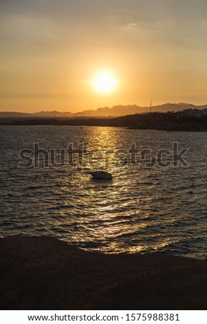 Lonely yacht in the sea at sunset