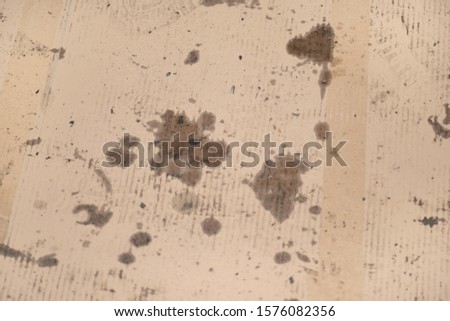 Oil stains on cardboard. Cheap oil leak absorbing.