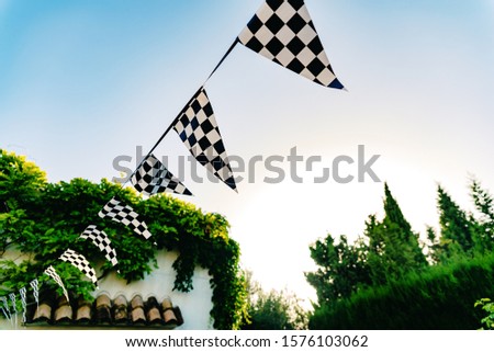 Hanging decoration pennants with the design of a checkered flag.