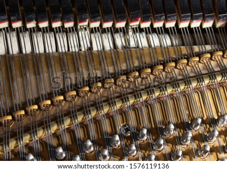 close up of acoustic piano mechanism and keys