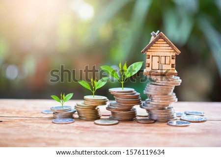 house model on money coins saving for concept investment mortgage fund finance and home loan refinance Royalty-Free Stock Photo #1576119634