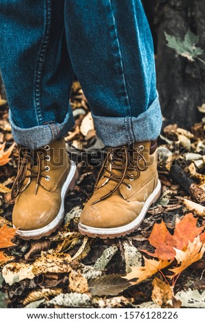Standing on the stump of an old tree. Boots on the top of the tree stump. Wood Background.Tree Picture.