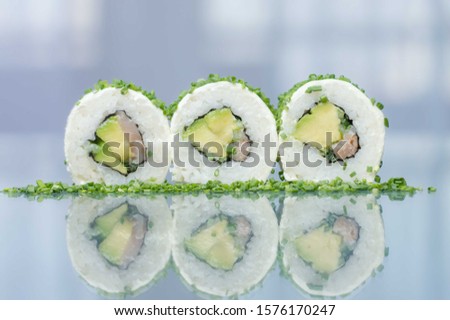 exotic Japanese sushi roll with vegetables and raw fish