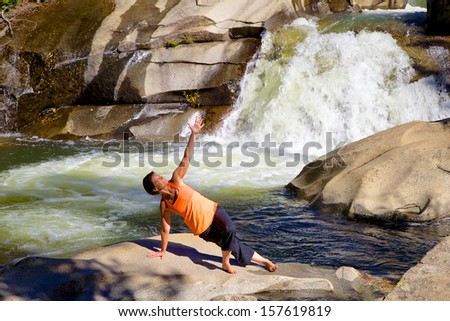 Practicing Yoga at a Waterfall
