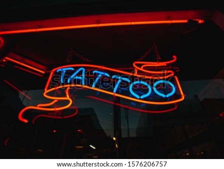 Tattoo neon sign at windows store