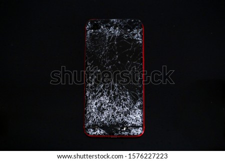 broken phone on black background