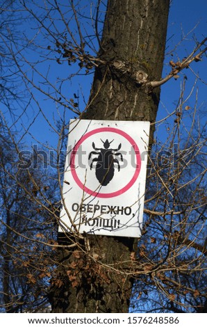 Danger - Ticks (UKR). Tick insect meningitis warning sign in nature . Lyme disease and tick-borne meningoencephalitis transmitter.Kiev
